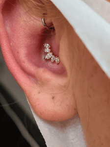 Conch piercing done at Eternal Gold in Glasgow with a 14kt yellow gold CZ prong set pice