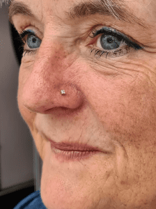 Nostril piercing performed by Jane at Eternal Gold in Glasgow with a 14kt yellow gold piece