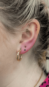 Stacked lobe pierced at eternal gold with titanium opals
